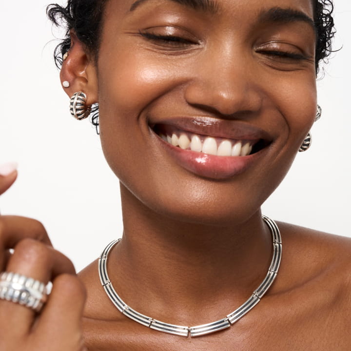 Image of the Barrel Necklace and Hoops on a model.