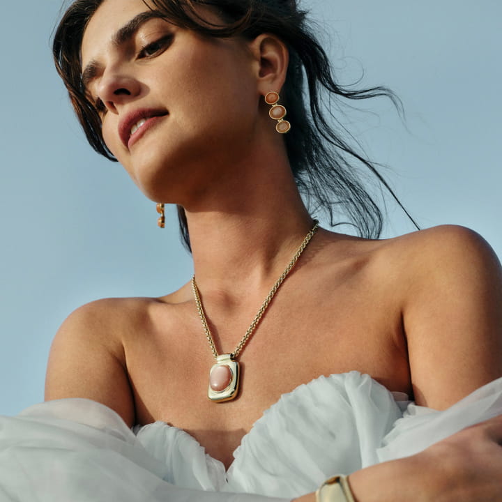 Mackinley Hill in the Peeled Necklace and Pulp Earrings in peach moonstone.