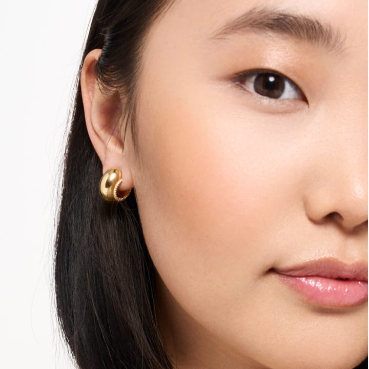 Image of a model wearing the Small Disc Hoops in gold vermeil.