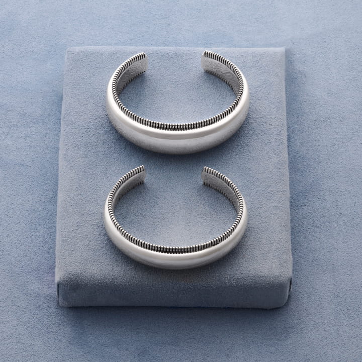 Still life image of the Bold Disc Cuff and Disc Cuff in sterling silver.