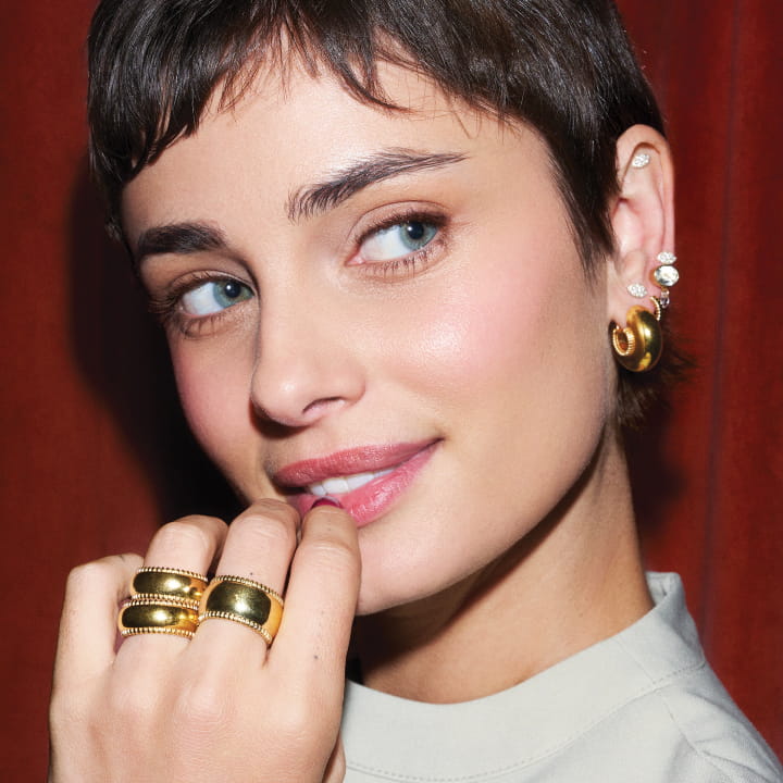 Image of Taylor Hill wearing the Small Disc Rings, Large Disc Ring, and Large Disc Hoops all in gold vermeil.